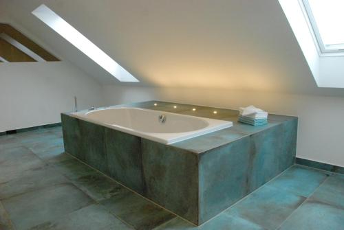 a large bath tub in a room with a ceiling at Sweet Clementine B & B in Hannover