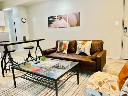 a living room with a couch and a glass table at Great location in Midtown! in Houston