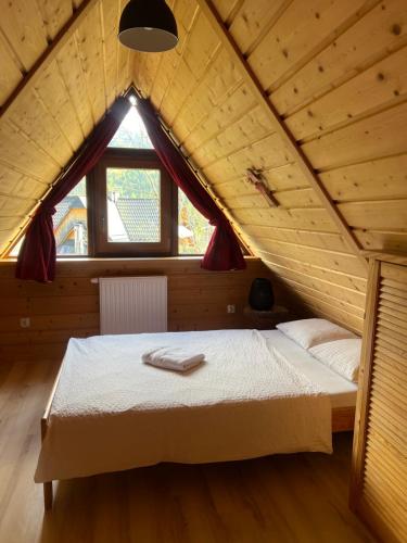 a bedroom with a bed in a attic at Chata u Wozniaka in Kościelisko