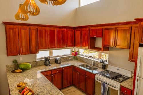 a kitchen with wooden cabinets and a sink at Umaya Resort & Adventures in Maya Beach