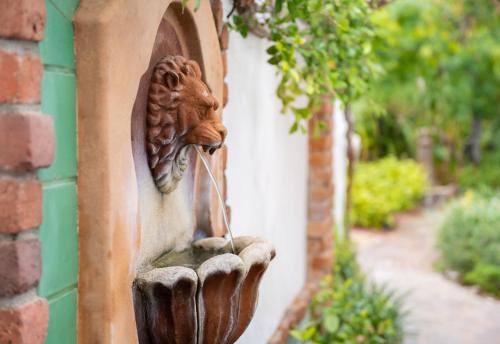 a statue of a lion on the side of a building at Lucille Palm Springs in Palm Springs