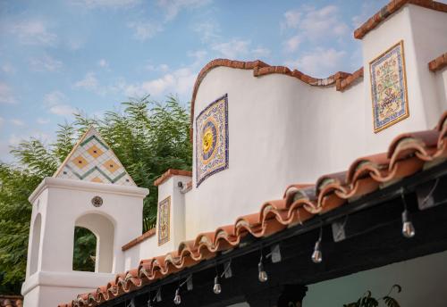a building with a tile roof and a tower at Lucille Palm Springs in Palm Springs