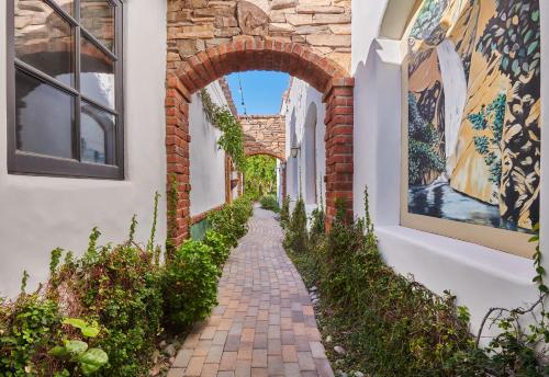 a brick alley way with an archway in a building at Lucille Palm Springs in Palm Springs