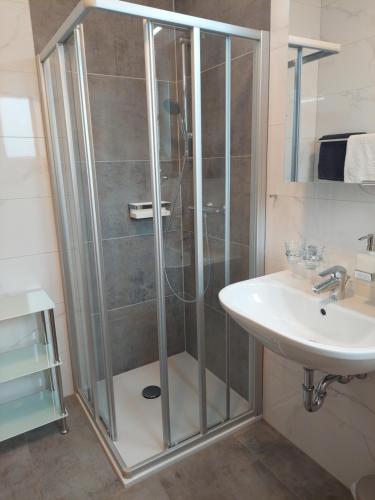 a bathroom with a shower and a sink at Pension Paßler in Seeboden
