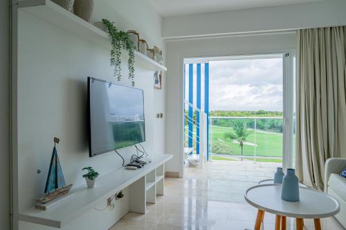a living room with a flat screen tv on a wall at Xeliter Cana Rock Punta Cana in Punta Cana