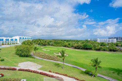 an aerial view of a golf course with palm trees at Xeliter Cana Rock Punta Cana in Punta Cana