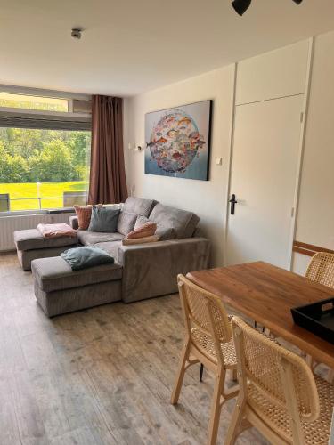a living room with a couch and a table at Vakantiehuisje Martina 11 in Vlissingen