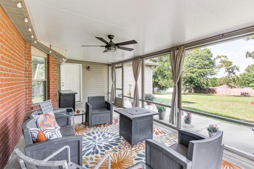 a screened porch with chairs and a ceiling fan at Crestview Family Home Screened Porch and Games! in Crestview