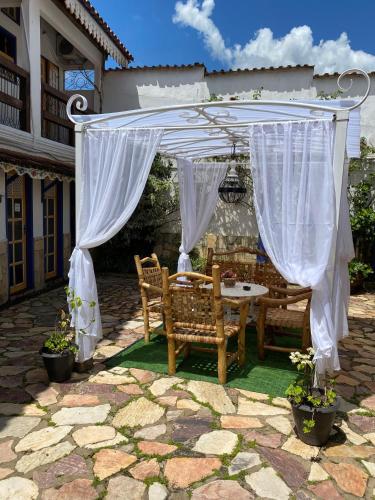 a gazebo with a table and chairs under it at Pouso das Gerais in Tiradentes