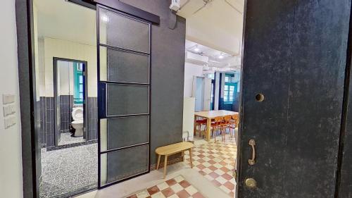 a door to a room with a table and chairs at Habyt Bridges - 6-8 Wa In Fong Street in Hong Kong