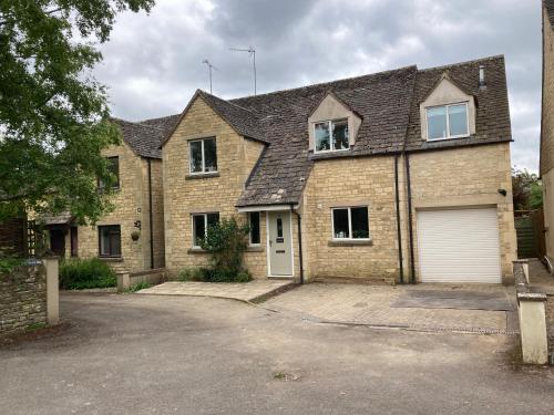 a large brick house with a white garage at Trinity House in Broadwell