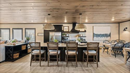 a kitchen with a large island with bar chairs at Royce' s Retreat in Sevierville