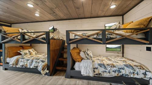 two bunk beds in a room with wooden walls at Royce' s Retreat in Sevierville