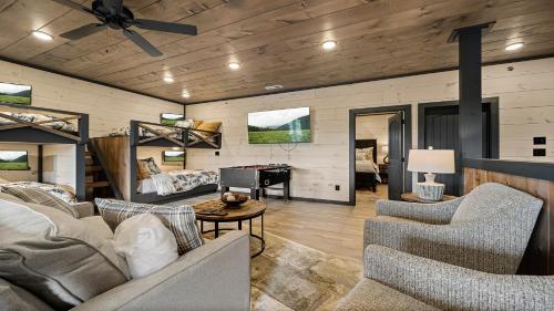 a living room with couches and a piano at Royce' s Retreat in Sevierville