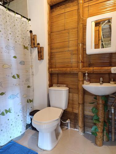 a bathroom with a toilet and a sink at Cabaña El Ensueño in Santa Rosa de Cabal