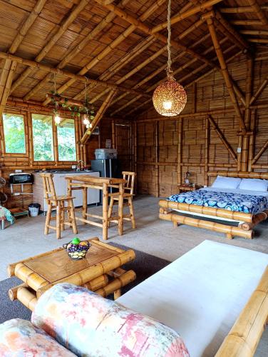 a room with a bed and a table and chairs at Cabaña El Ensueño in Santa Rosa de Cabal