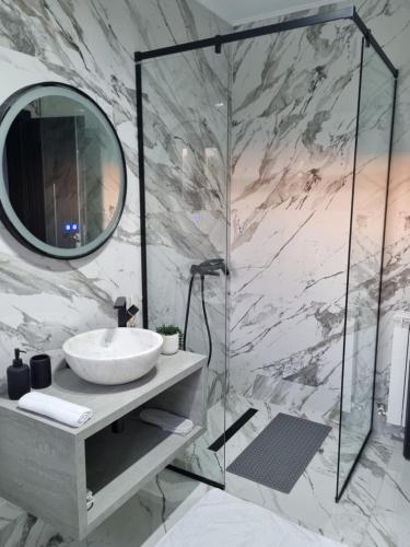 a bathroom with a sink and a mirror at Villa Twins Techirghiol in Techirghiol