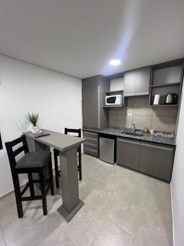 a kitchen with a table and chairs in a kitchen at MyA Apartaments in San Luis