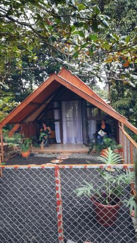 a small house with two people sitting in it at Villa Campo's in Venecia