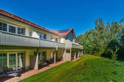 an exterior view of a house with a yard at Naturresort & Spa Schindelbruch in Stolberg i. Harz
