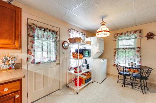 a kitchen with a white refrigerator and a table at Charming West Mifflin House - 3 Mi to Kennywood! in West Mifflin