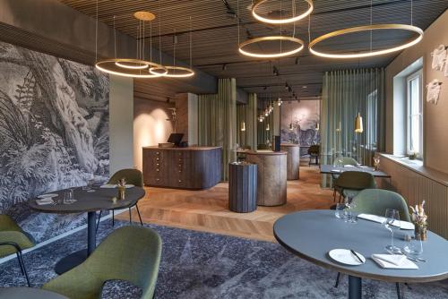 a restaurant with two tables and chairs and a counter at Naturresort & Spa Schindelbruch in Stolberg i. Harz