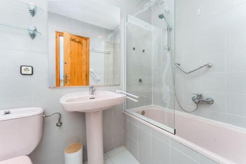 a bathroom with a sink and a toilet and a shower at Playa Carabassi Villa in Puerto Marino