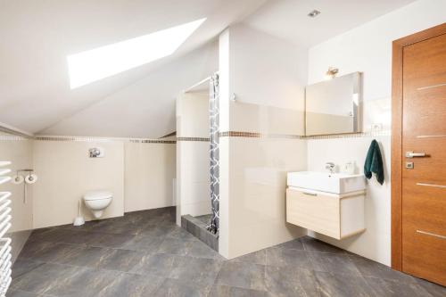 a bathroom with a toilet sink and a mirror at Dom Wypoczynkowy Zalesie in Przanowice