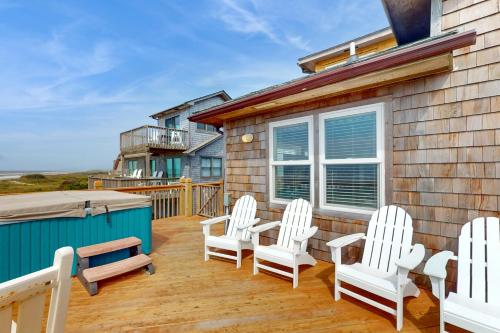 a deck with white chairs and a hot tub at Simplify #1F in Frisco