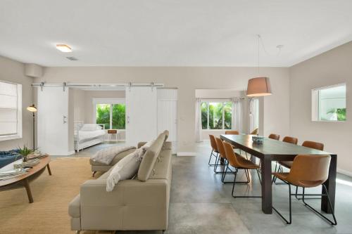 a living room with a table and a dining room at Stunning Home LifeStyle Miami in Miami