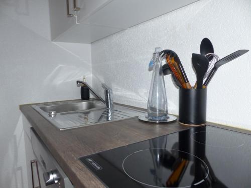 a kitchen counter with a sink and a kitchen utensils at Sweet Home in Murten