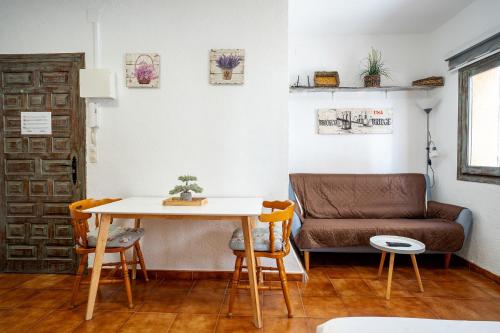 a living room with a table and a couch at Loft con encanto in L'Ametlla de Mar