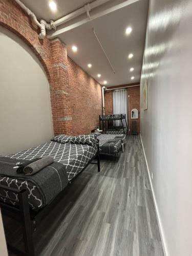 a room with two beds and a brick wall at 31 Street Broadway Hotel in New York