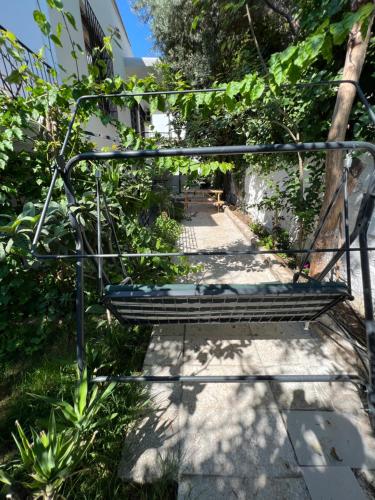 a bench in a garden with a pathway at Konukzade OldTown Apart in Antalya