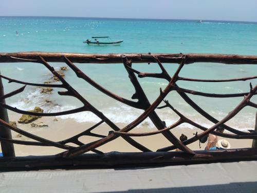 a view of a beach with a boat in the water at HOSTAL LAMAR BARU dónde Gertrudis in Playa Blanca