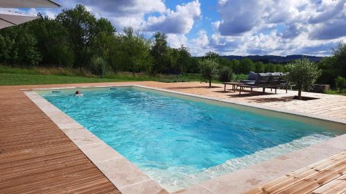 - une piscine avec une personne dans l'eau dans l'établissement La Grange de Lucie -chambres d'hôtes en Périgord-Dordogne, à Nanteuil-Auriac-de-Bourzac