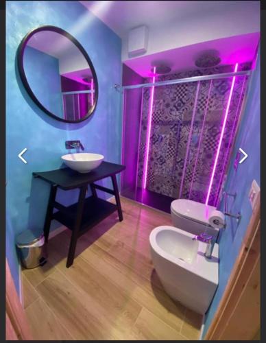 a bathroom with a sink and a mirror and a toilet at locanda genovese 20 in La Maddalena
