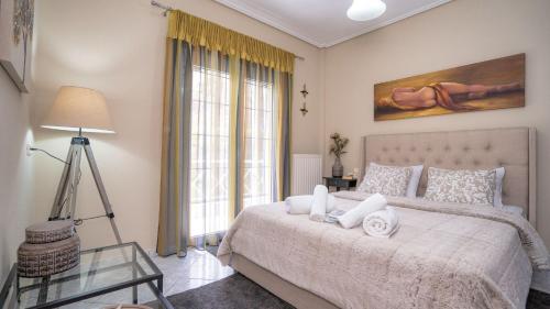 a bedroom with a large bed and a window at Boutique St Stephens Residence in Kalabaka