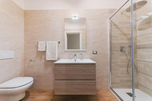 a bathroom with a toilet and a sink and a shower at Apulia Rooms Bari in Bari