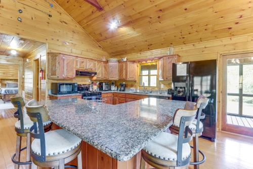 a kitchen with a granite counter top in a cabin at Waterfront Cabin in Ellijay Hot Tub and Game Room in Ellijay
