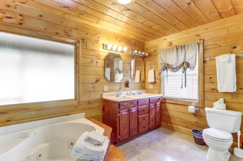 a log cabin bathroom with a tub and a toilet at Waterfront Cabin in Ellijay Hot Tub and Game Room in Ellijay