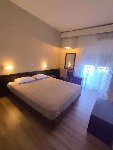 a bedroom with a large bed in a room at Plaza Hotel in Alexandroupoli