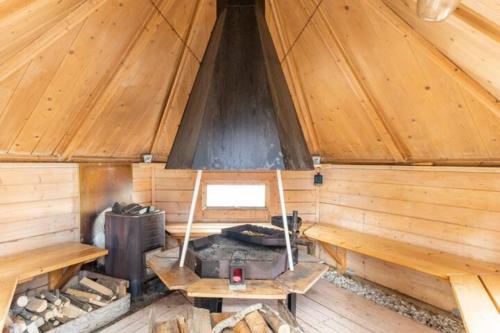 an inside of a wooden cabin with a stove at 3 Bedroom Cottage with Sauna by the Sea in Vaasa