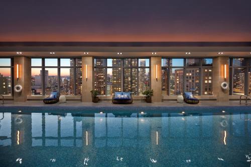 a hotel swimming pool with a view of the city at Mandarin Oriental, New York in New York