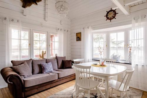 a living room with a couch and a table at 3 Bedroom Cottage with Sauna by the Sea in Vaasa