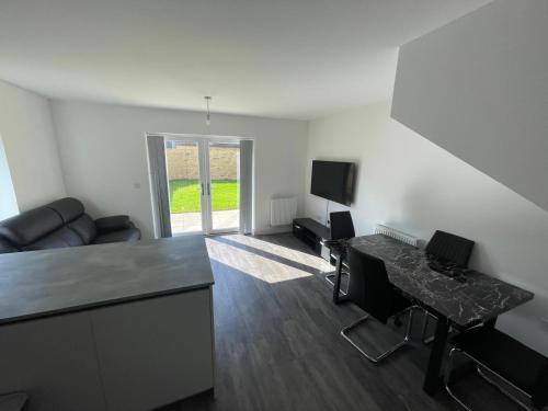 a living room with a couch and a table at Home in Greenhithe in Kent