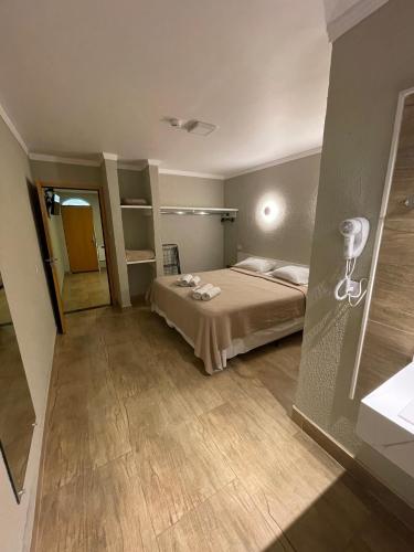 a bedroom with a bed in a room at Hotel Fazenda Santa Monica in Louveira