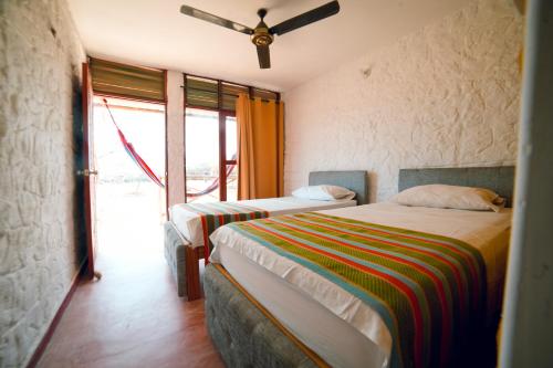 a bedroom with two beds and a window at El Remanso del Santuario in Camarones