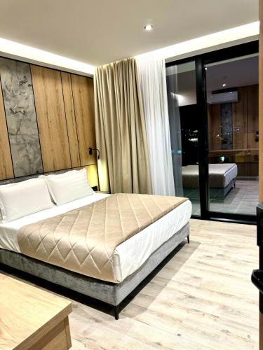 a bedroom with a large bed in a room at Hotel Joni Premium in Ksamil