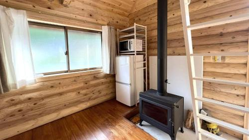 a living room with a stove and a refrigerator at New Kurumi Land - Vacation STAY 41991v 